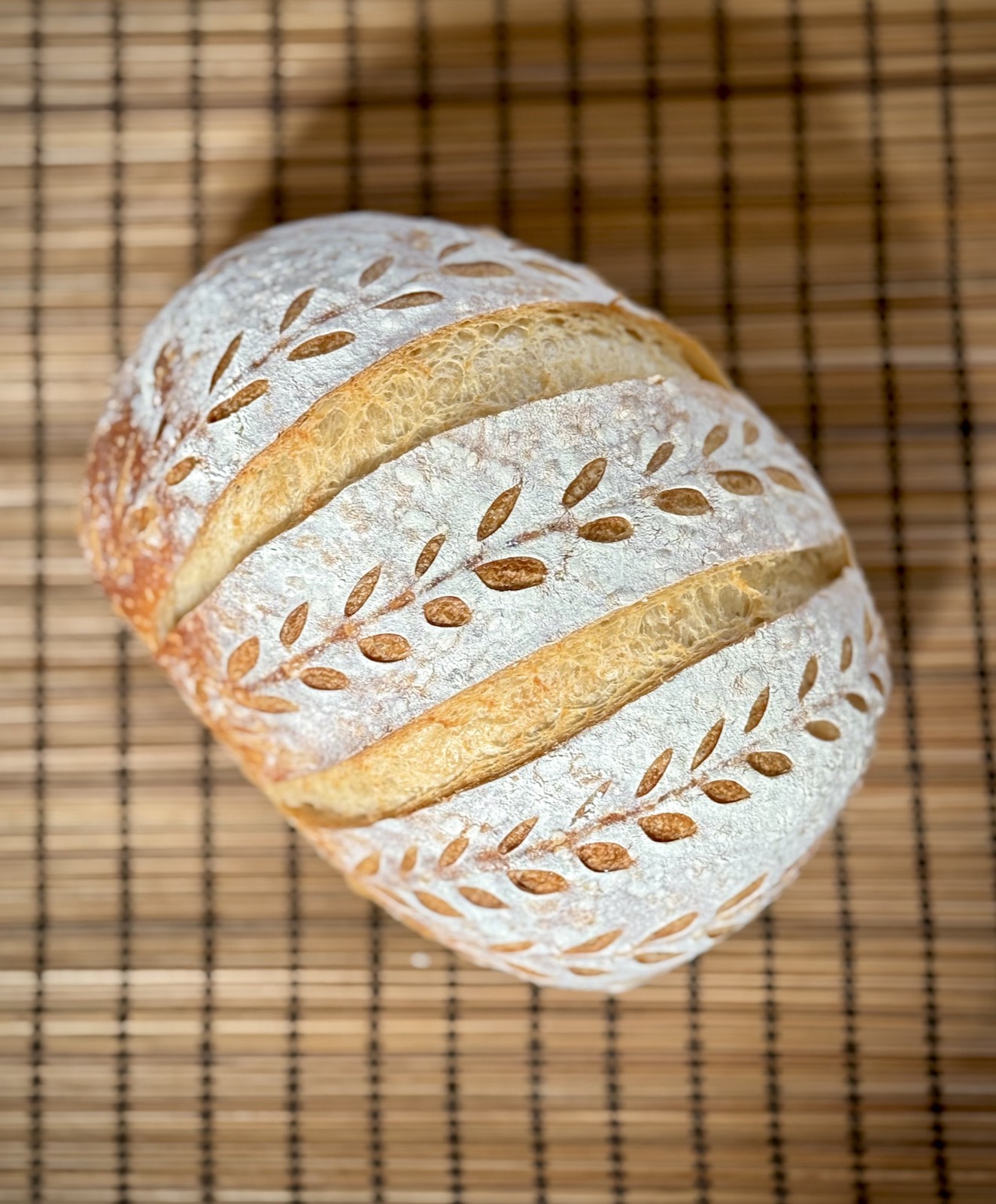Two sourdough sandwich loaves cooling on a rack in the home kitchen